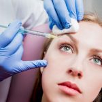 beautician and the patient in the clinic of aesthetic medicine.